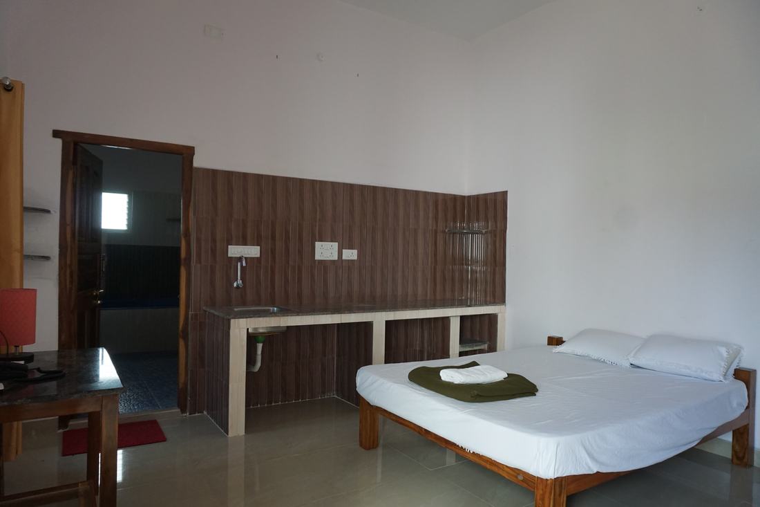 Jala room G2, Art Le Cafe Auroville — bed with sink and worktop