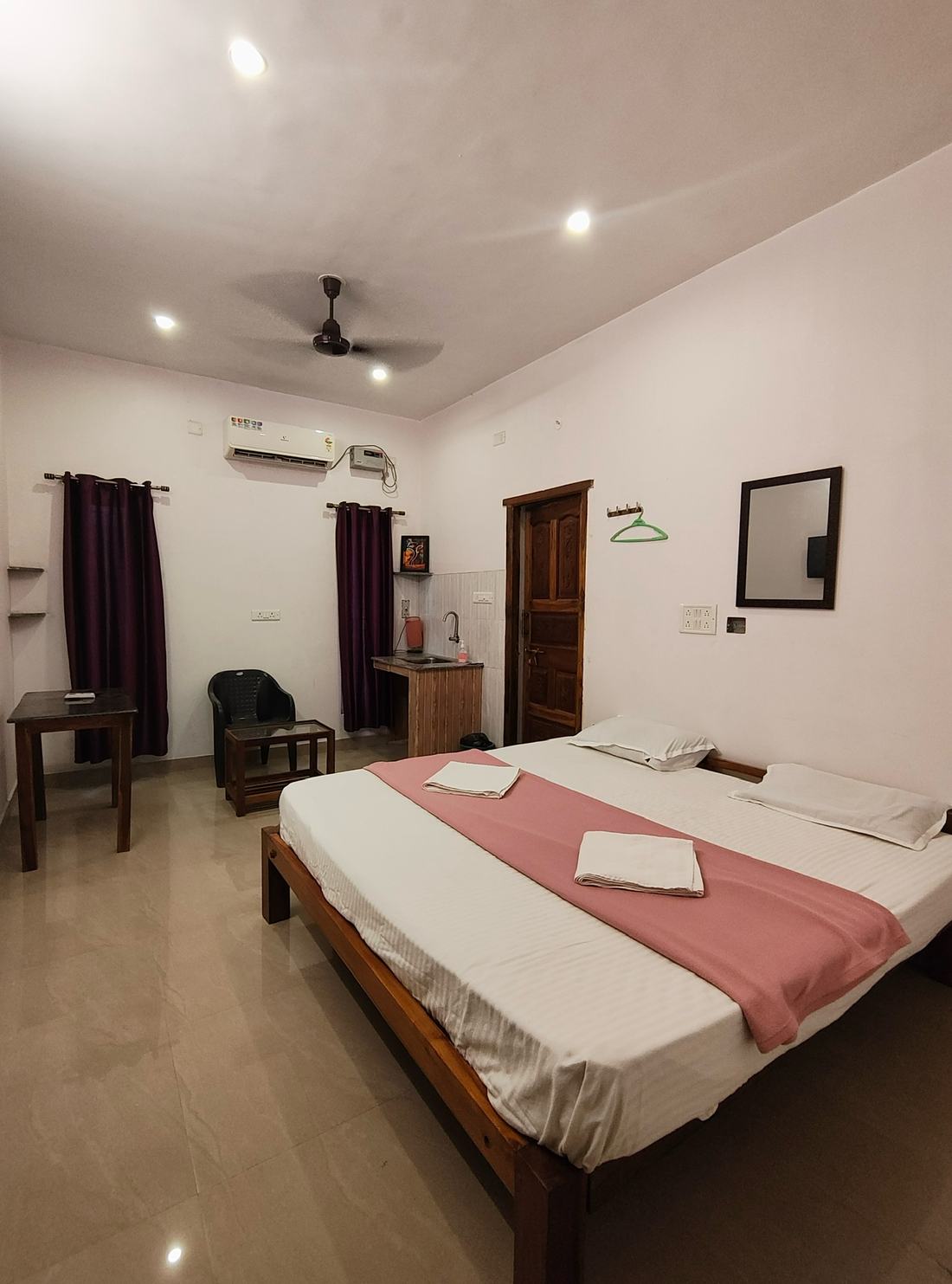 Aakash room G5, Art Le Cafe Auroville — bed with AC and sink area