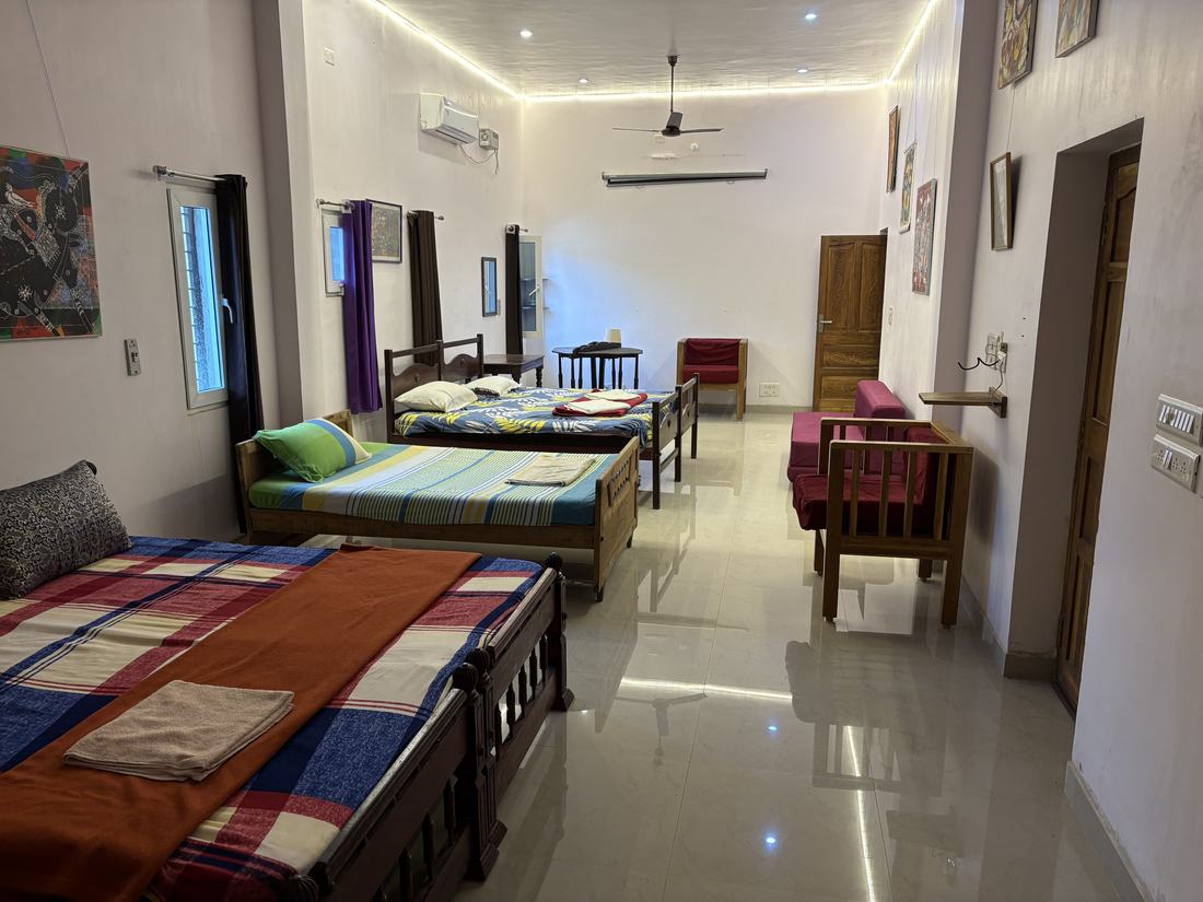Room G6, Art Le Cafe Auroville — multiple beds and seating area