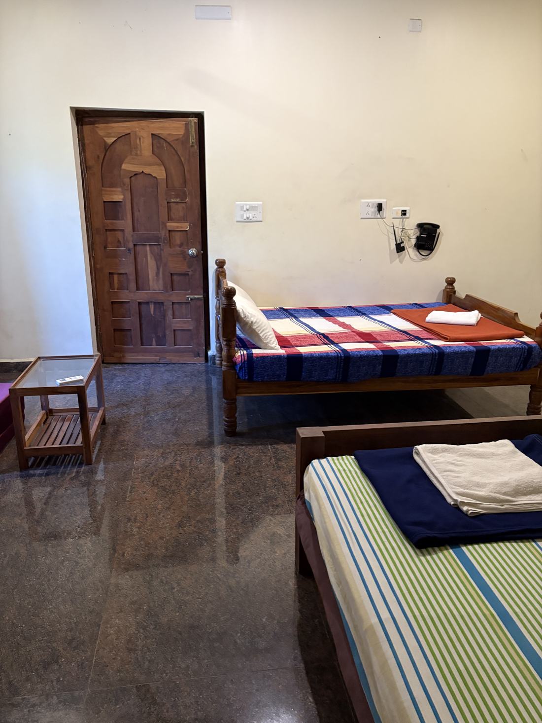 Agartha room F7, Art Le Cafe Auroville — beds and entrance door