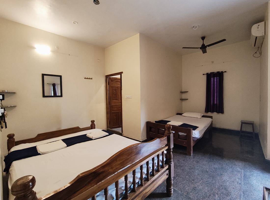 Agartha room F7, Art Le Cafe Auroville — double bed and single bed layout
