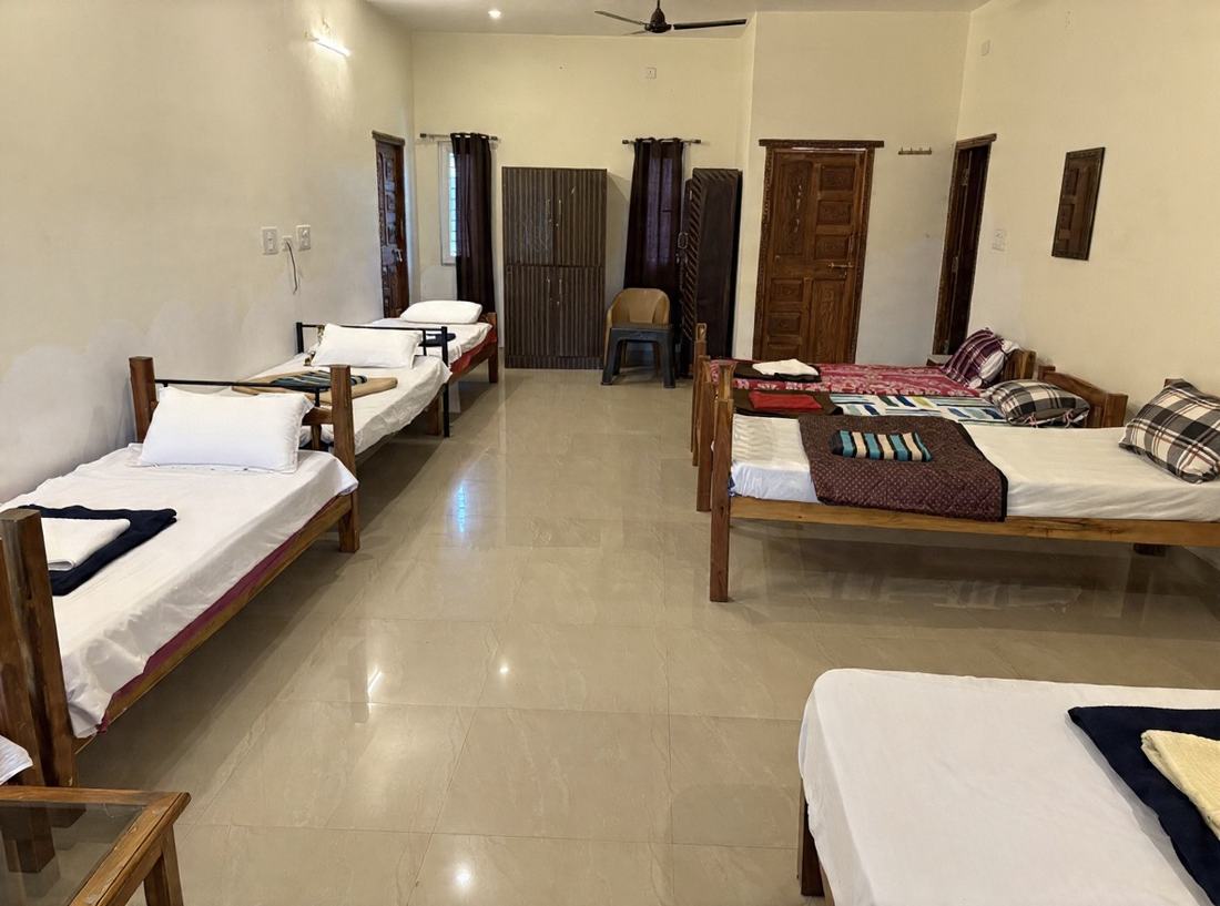 Shambhala dormitory F11, Art Le Cafe Auroville — row of single beds