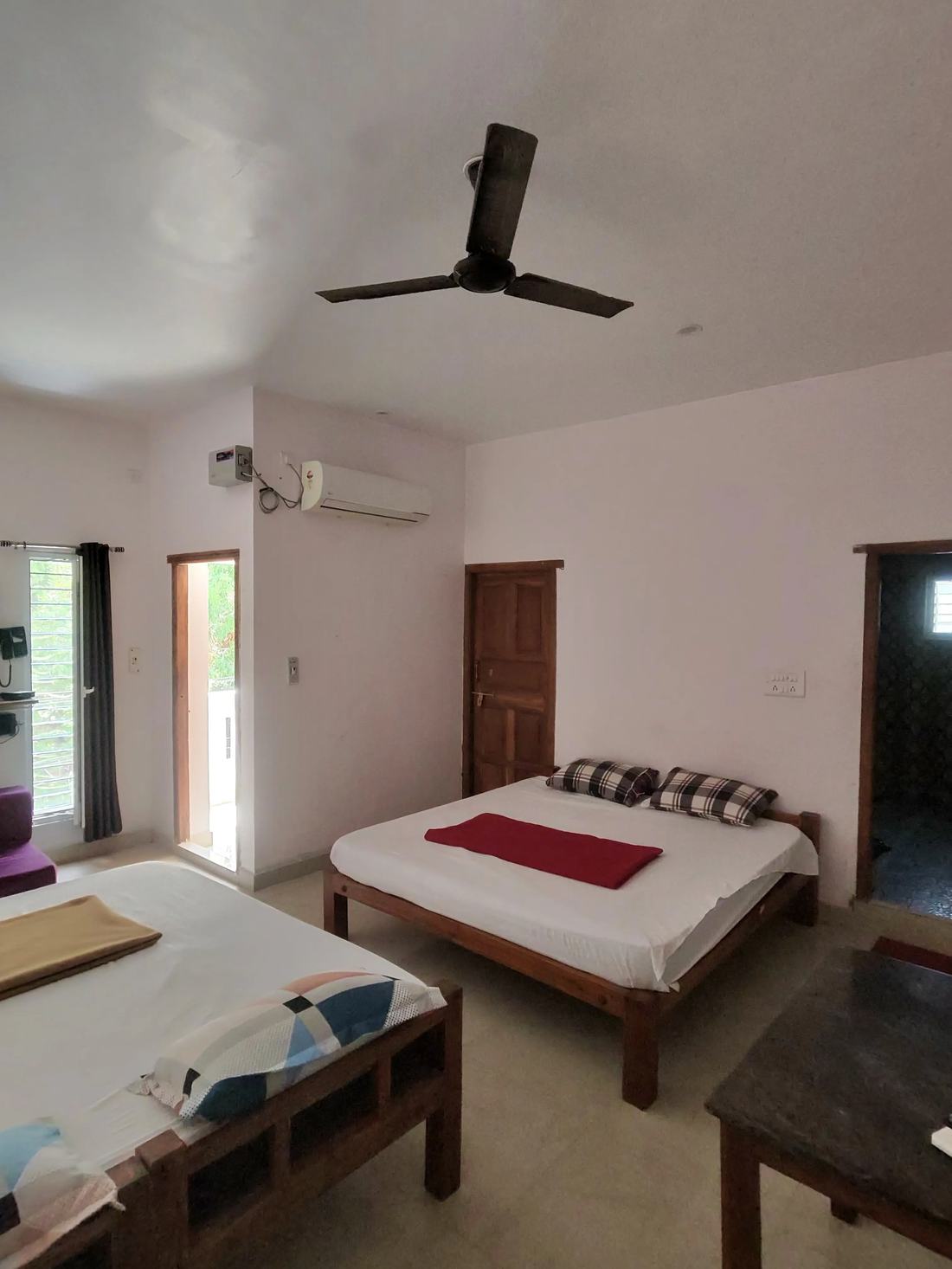 Utopia room F13, Art Le Cafe Auroville — beds and AC unit