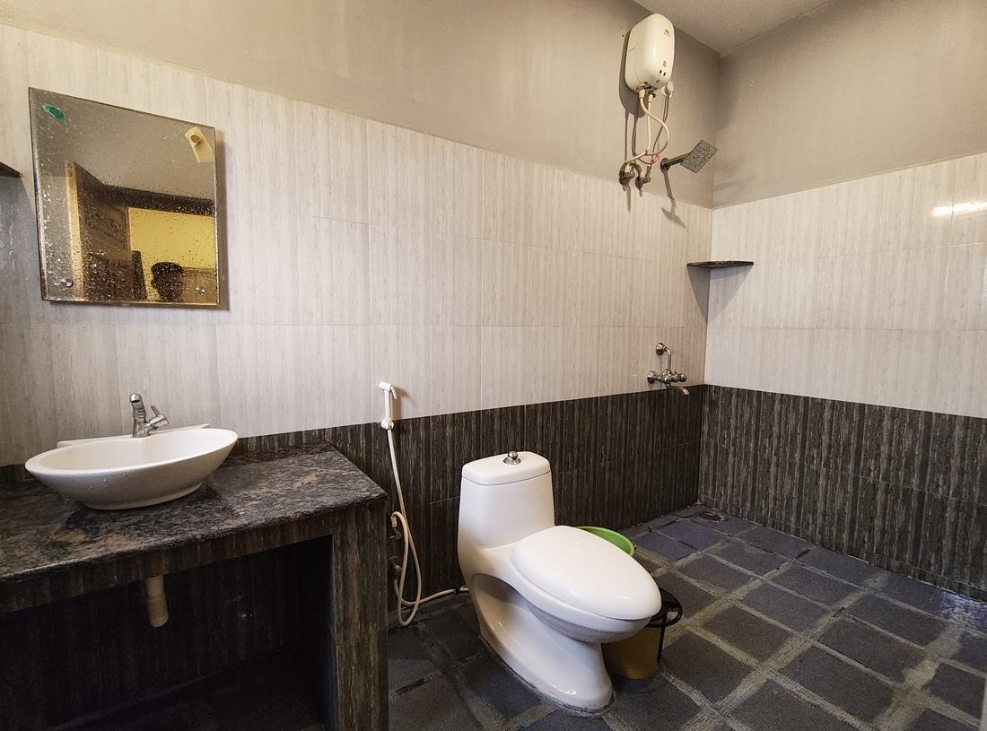 Shangri-La room F14, Art Le Cafe Auroville — bathroom with sink and toilet