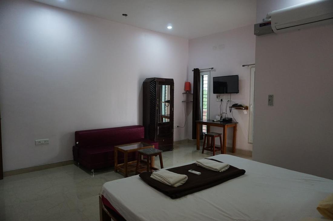 Zeus room S14, Art Le Cafe Auroville — sofa, wardrobe and TV