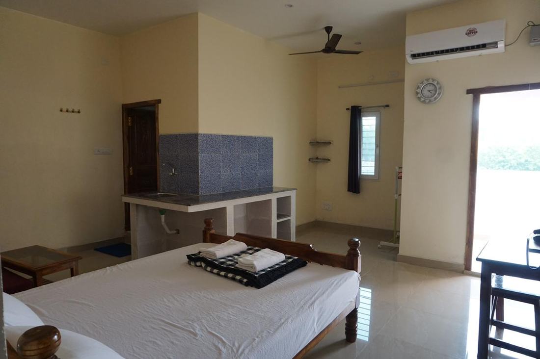 Ganesha room S17, Art Le Cafe Auroville — bed, sink and AC