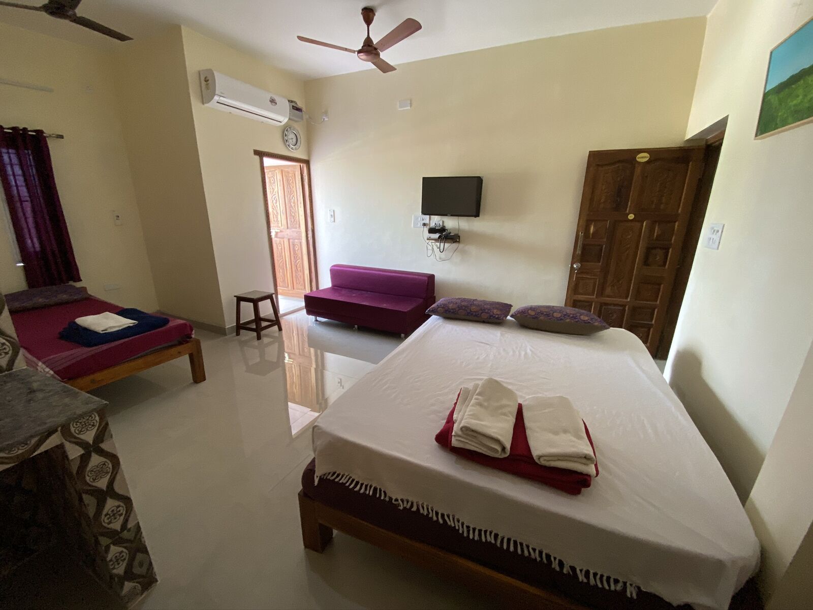 Lakshmi room S22, Art Le Cafe Auroville — beds, sofa and TV