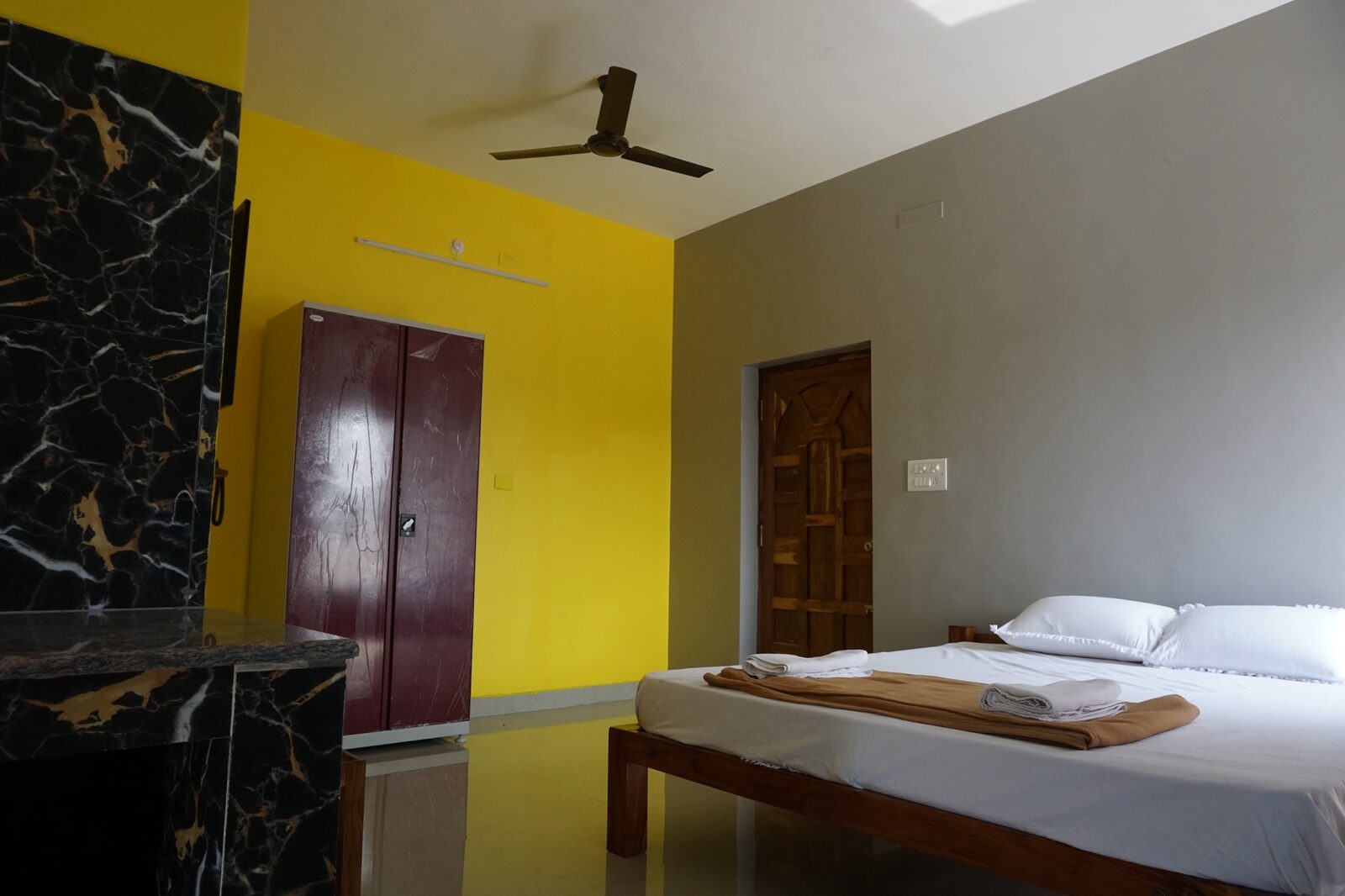 Kubera room S21, Art Le Cafe Auroville — bed and wardrobe